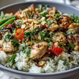 Vibrant Thai Chicken Coconut Bowl with sautéed chicken, crisp red bell pepper, snap peas, and aromatic herbs.