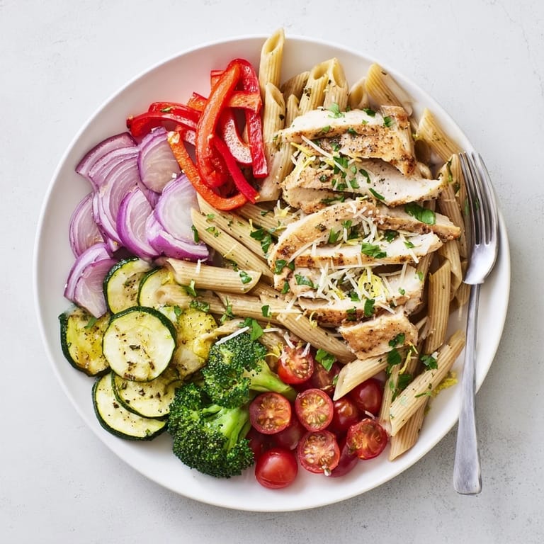 Penne pasta tossed with sliced garlic-herb chicken, broccoli, and bell peppers in a light, aromatic sauce.